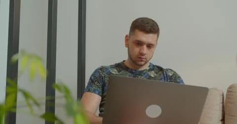 Man freelancer using laptop online working in internet, guy typing on computer Foto stock