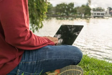 Man freelancer using laptop outdoor Stock Photos