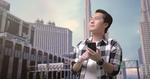 Man Freelancer Using Smartphone And Looking Around While Standing In Front Stock Footage 245288017