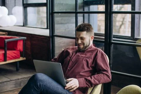 Man freelancer working on computer at home Stock Photos