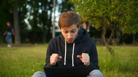 Man freelancer working on the lake with a tablet computer, image at sunset. The  Stock Footage 76740517