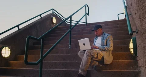 Man freelancer working on laptop beech outdoors in the city Stock Footage 245753337