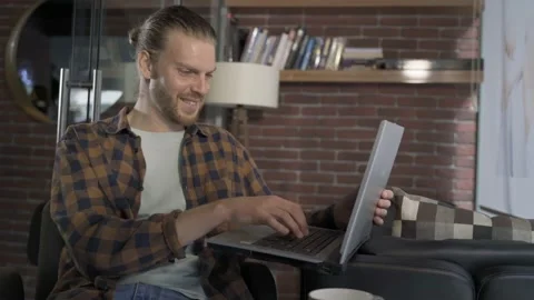 Man freelancer working on a laptop in cafe Stock Footage 171673046