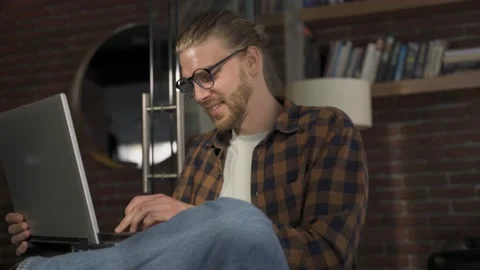 Man freelancer working on a laptop in cafe Stock Footage 171673224