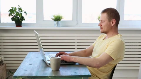 Man freelancer working remotely at home on laptop Stock Footage 91204370