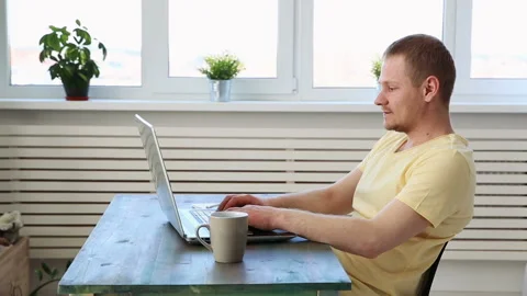 Man freelancer working remotely at home on laptop 動画素材 91206439