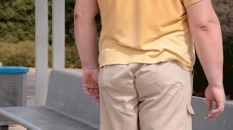 Man frees pants from the captivity of his backside Video stock 68619182