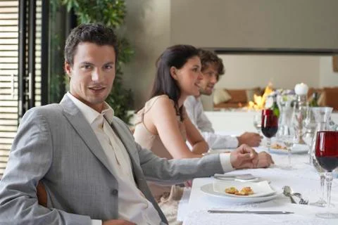 Man With Friends Having Formal Dinner Party Stock Photos