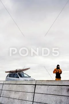 Man In Front Of Car With Kayak