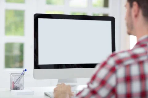 Man in front of computer screen Stock Photos