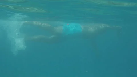 A man front crawling in the water Stock Footage 231411359