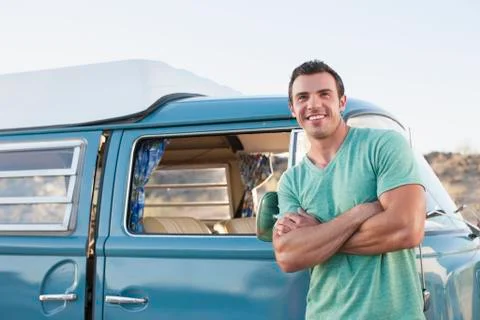 Man in front of his mini van during road trip Stock Photos