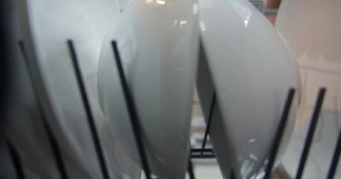 A man in front of an open dishwasher takes out or puts down dishes. Stock Footage 264584952