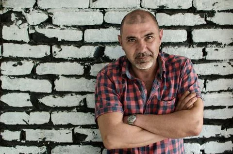 Man in front of white brick wall Stock Photos