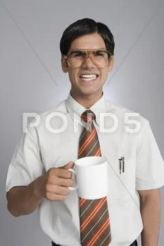 Man frowning over a coffee cup Stock Photos