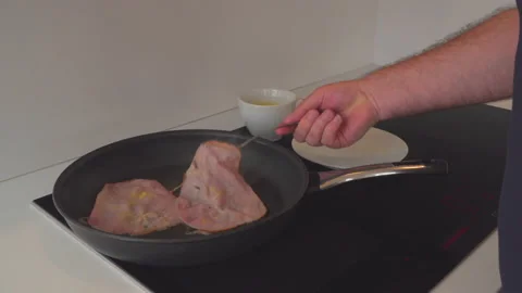 Man fry bacon in kitchen Stock Footage 144956014