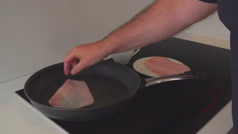 Man fry bacon in kitchen Stock Footage 144956097