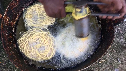 A man frying and preparing snacks Stock Footage 100865506