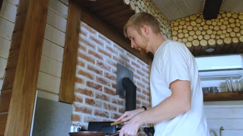 Man frying eggs in a pan Stock Footage 200819213