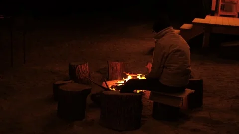Man frying marshmallows Stock Footage 168755514