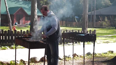 Man frying meat on the grill Stock Footage 55544174
