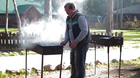 Man frying meat on the grill Stock Footage 55544176