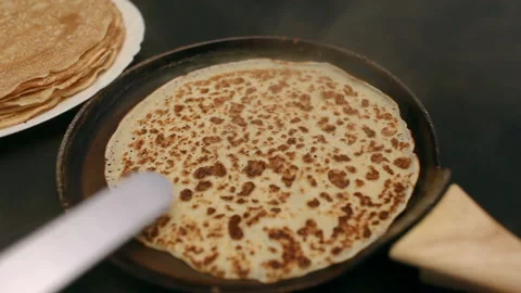 Man frying pancakes Stock Footage 169727973