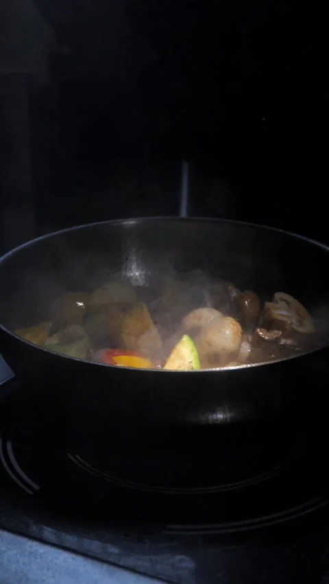 Man frying vegetables and meat in sauce, throwing in a frying pan. Chef cooking Stock Footage 309463401