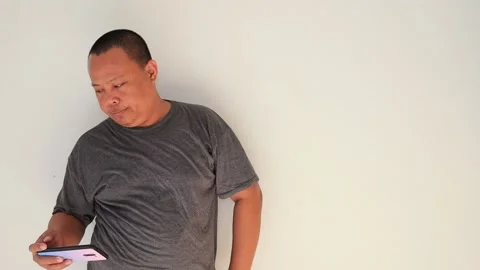 Man full of emotion typing a message on his smartphone Stock Footage 151081107