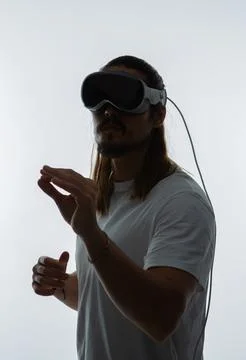 A man fully engaged in a spatial computing experience with a AR headset Fotos Stock