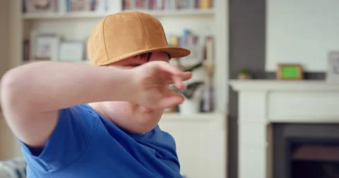 Man, fun and silly in living room, dance and moving with energy and celebration Stock Footage 335857247