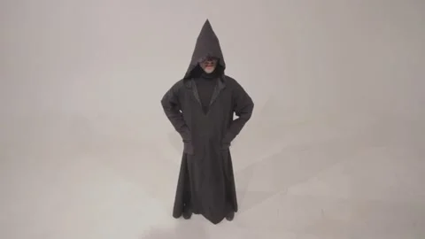 Man in a funny executioner costume posing against the empty white wall backgroun 스톡 동영상 241987240