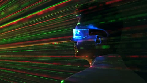 The man in futuristic glasses on a laser rays background Stock Footage 191479347