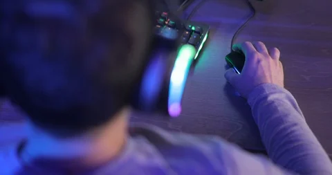 Man gamer playing computer game pressing mouse sitting at table, back view. Stock Footage 122483381