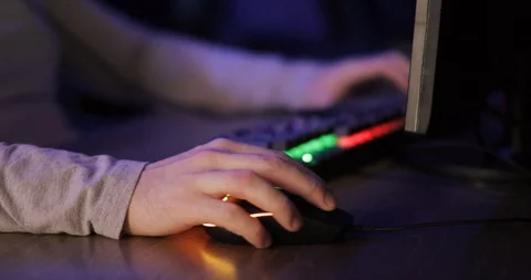 Man gamer is playing computer games sitting at table, hands closeup. Stock Footage 122481890