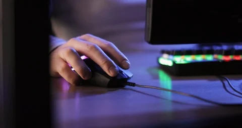 Man gamer playing computer games pressing mouse sitting at table, hands closeup. Stock Footage 122481974