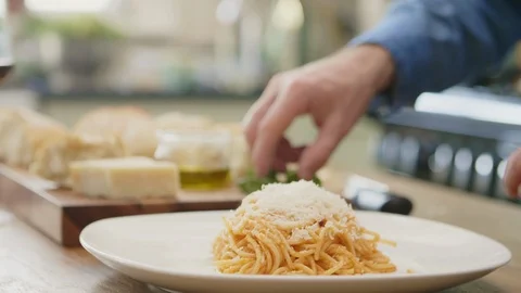 Man Garnishing Spaghetti With Basil On Plate At Kitchen Stock Footage 86078006