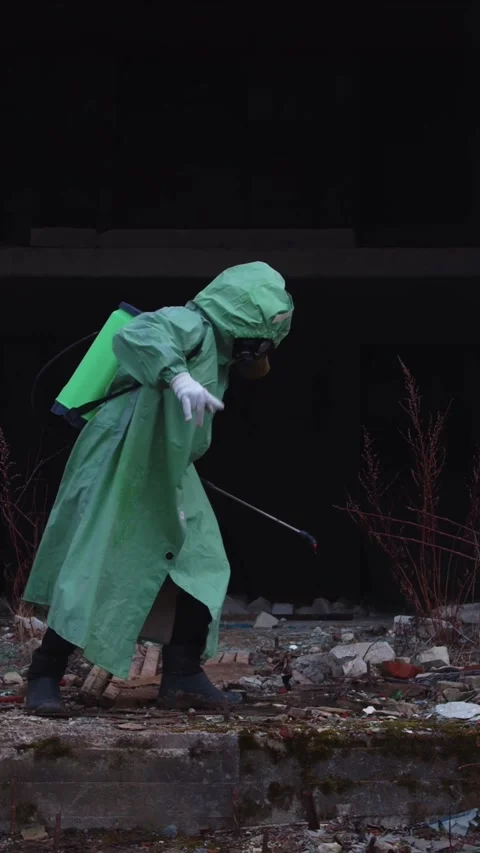 A man in a gas mask and a protective suit going crazy dancing in post Stock Footage 328280763