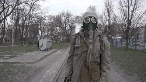 A man in a gas mask inspects an empty area. Post-apocalyptic ambient. Stock Footage 194536205
