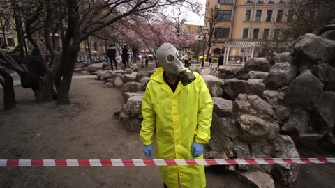 A man in a gas mask stands in front of a protective tape in the street Stock-Footage 132634857