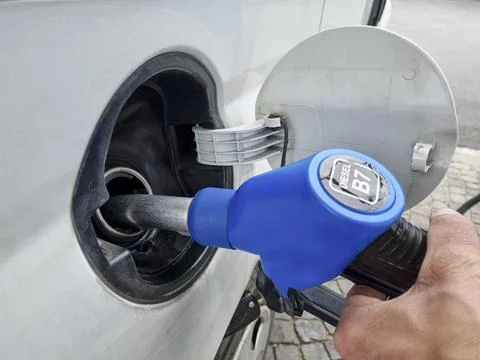 Man at Gas station while refueling a car,increasing petrol costs concept Stock Photos