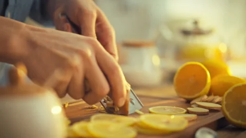 A man gently grates a brown fresh ginger root releasing its strong pungent a Stock Footage 331309365