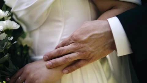The man gently runs his hand over the hand of his beloved Stock Footage 315791539