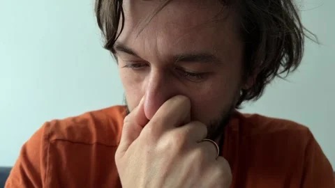 A man gently scratches his nose Stock Footage 336977972