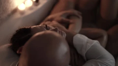 The man gently strokes the woman's face, she is relaxed  Stock Footage 313876131