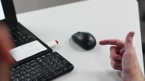 Man gestures explaining tasks at workplace with laptop Vídeos de archivo 283362279