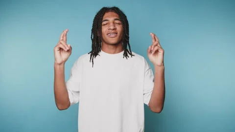 Man gestures to express ideas with hands against a blue background in a bri.. Stockbeeldmateriaal 328248766