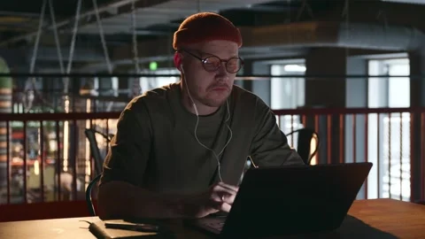 The man gestures with his hands, communicates via video using a laptop Stock Footage 258141282