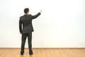The man gesturing on the background of the white wall background Photo