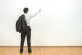 The man gesturing on the background of the white wall background Photo